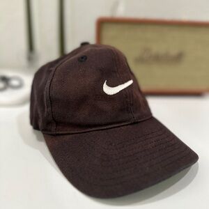 Faded brown Nike hat with white swoosh